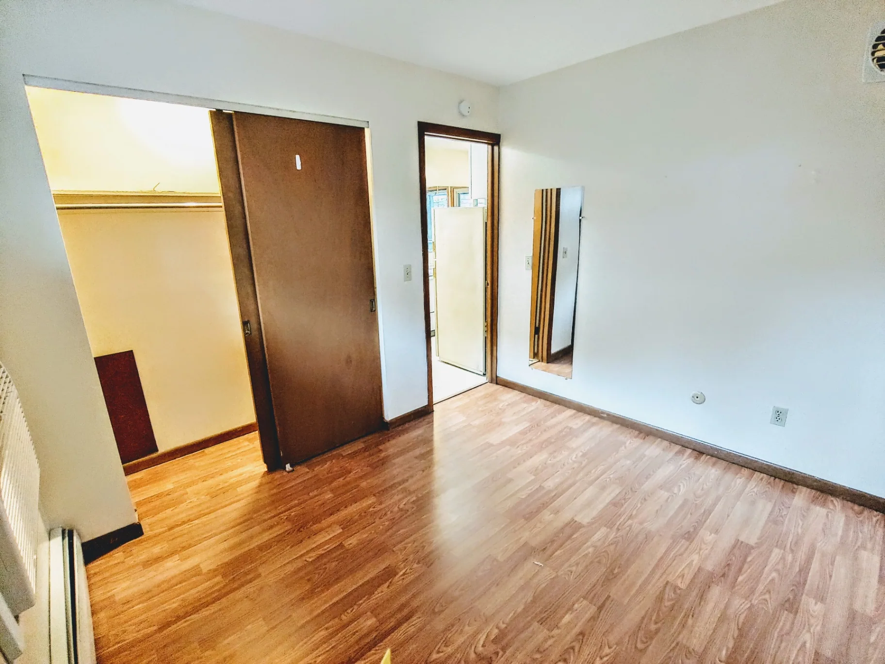 2040 Iuka Ave. 1A bedroom with sliding closet doors and full-length mirror