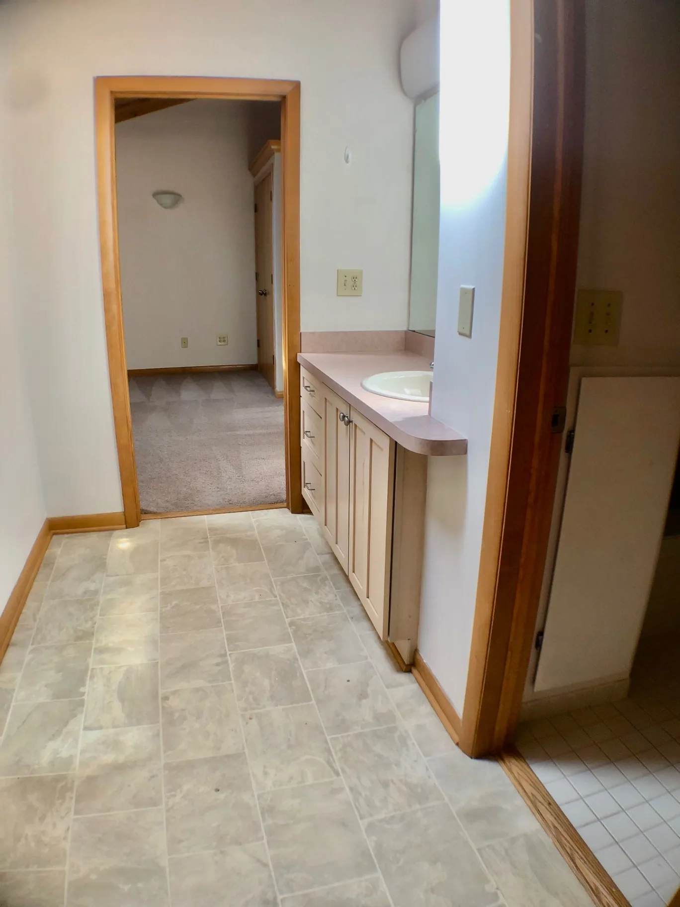 2040 Iuka Ave House bathroom hallway with vanity, mirror, and tile flooring