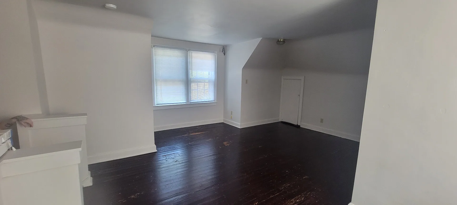 2044 Iuka Ave. C bright upper-level bonus room with two tall windows and open floor area