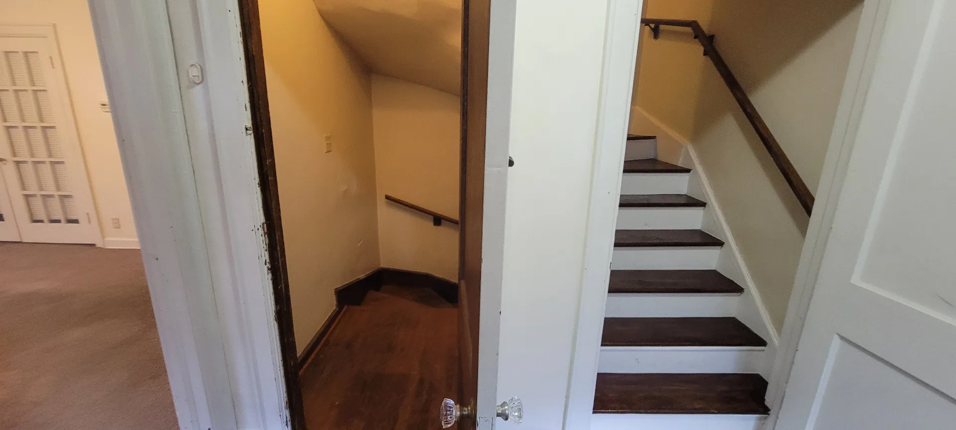2044 Iuka Ave. D private staircase entry with original glass-knob door leading up to the loft bedroom