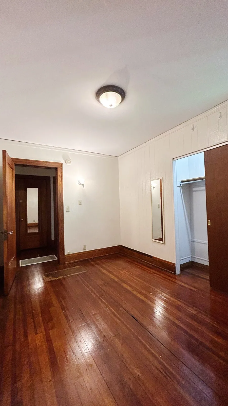 2026 Iuka Ave C bedroom with hardwood floors, wall sconce, and large closet