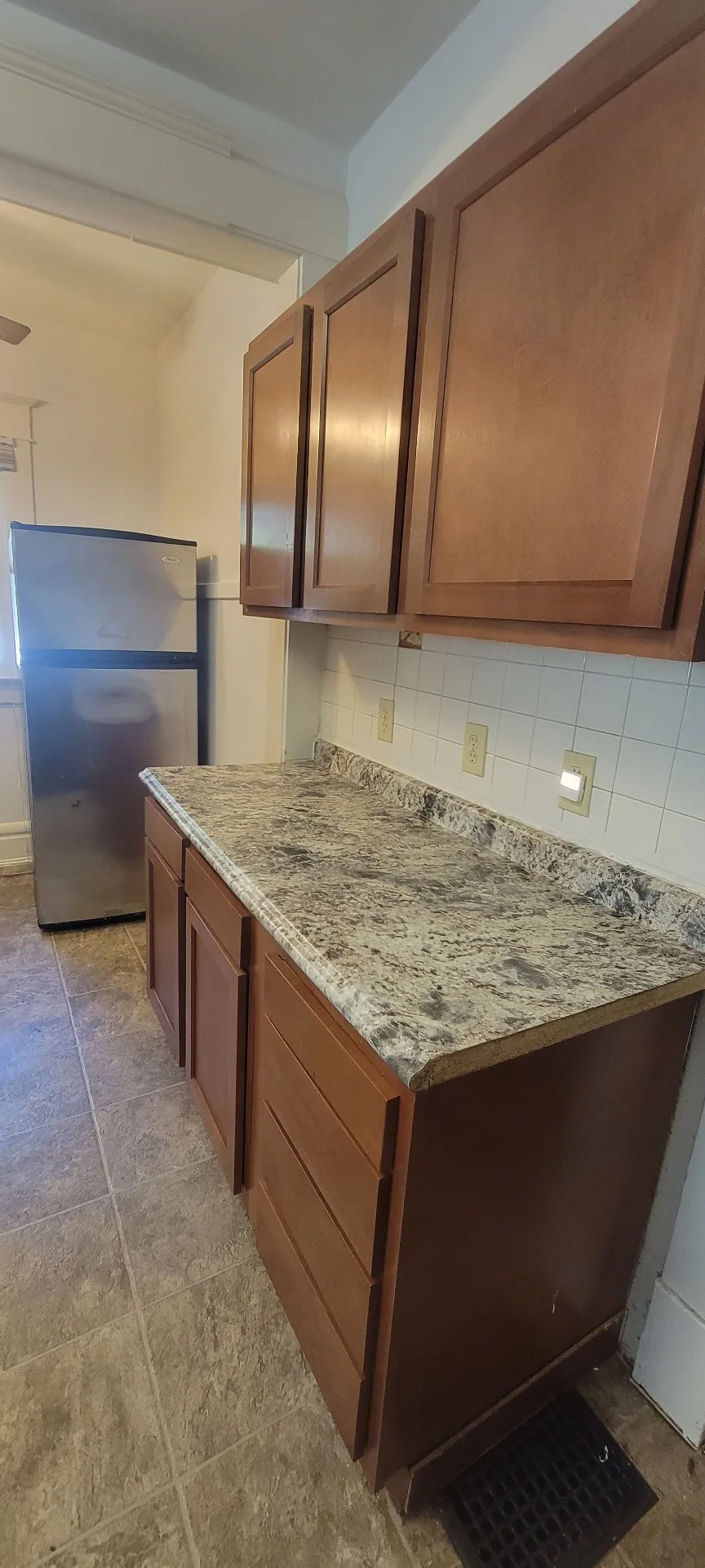 2015 Summit St. kitchen prep counter with maple cabinets and stainless refrigerator