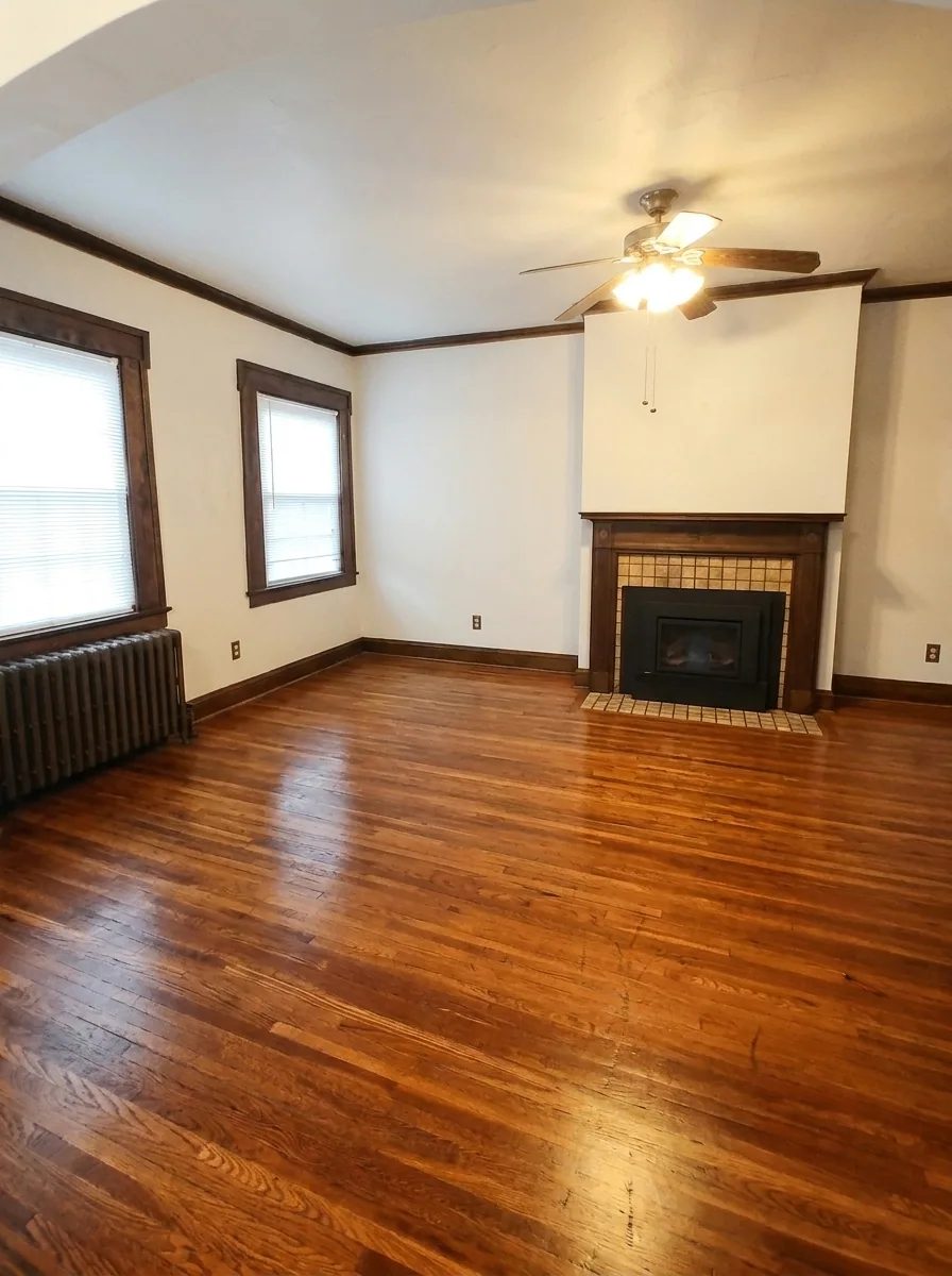 Unit C living room with gas insert fireplace and hardwood floors