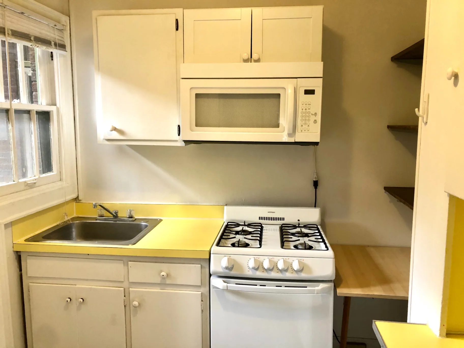 2044 Iuka Ave. B kitchen with gas range, microwave, and sunny window over the sink