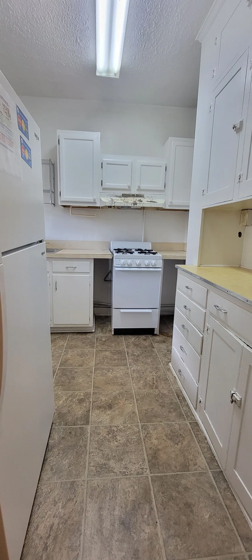 2044 Iuka Ave. D full kitchen with gas range, refrigerator, ample cabinetry, and tile flooring