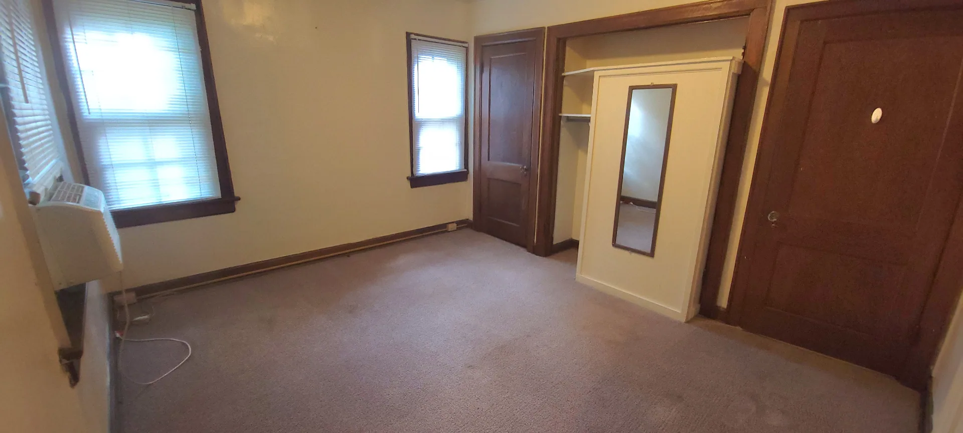 2054 Iuka Ave. C bedroom with closet, mirror, and two windows