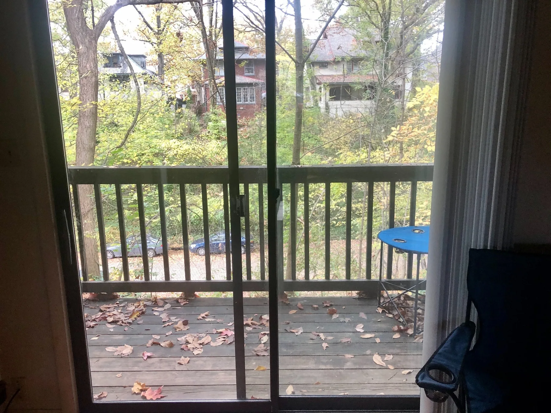 2020 Iuka Ave. private balcony view through sliding glass doors overlooking the wooded Iuka Ravine in autumn