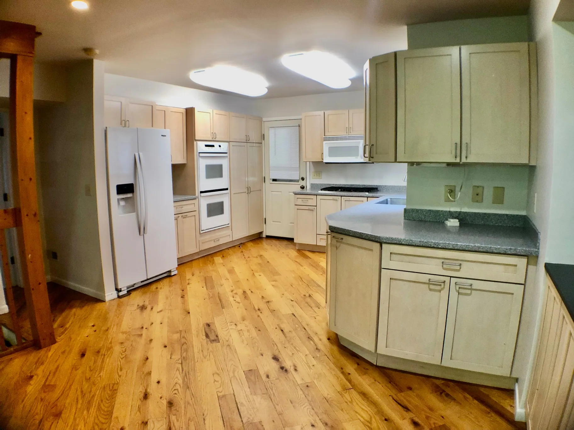 2040 Iuka Ave House kitchen with double wall oven, side-by-side fridge, and hardwood floors