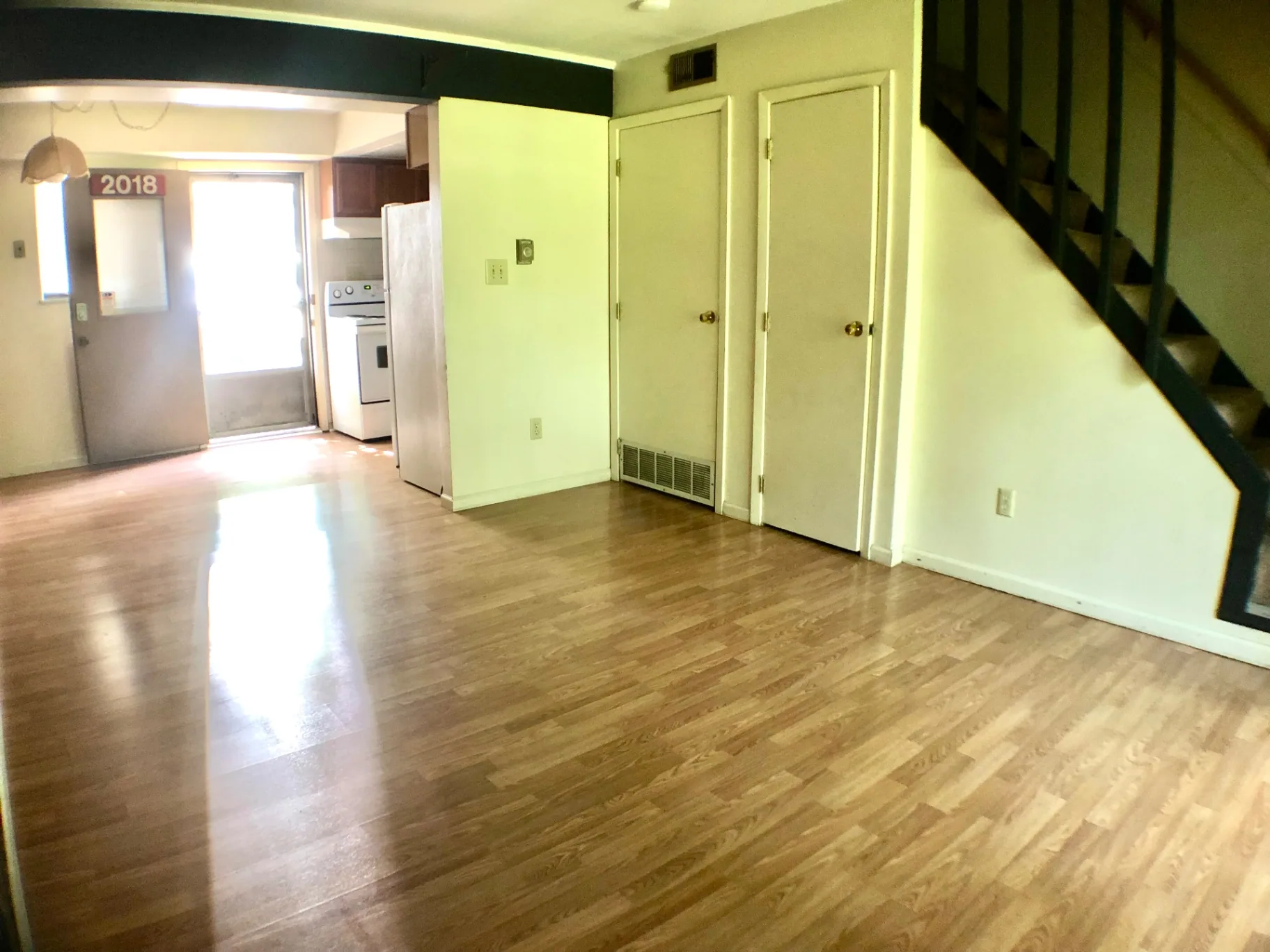 2018 Iuka Ave. living area with staircase, closets, and pass-through to the kitchen