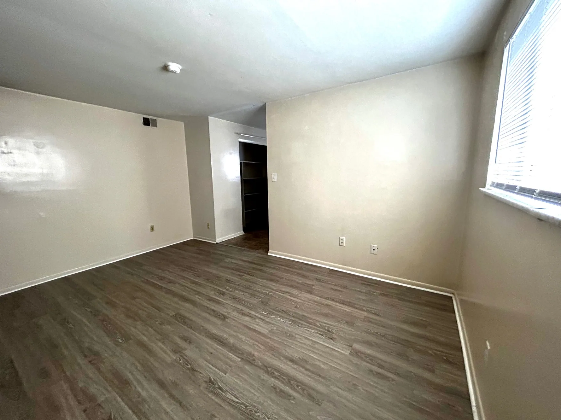 2150 N 4th St. Unit B bedroom with wood-look flooring, bright window, and closet nook
