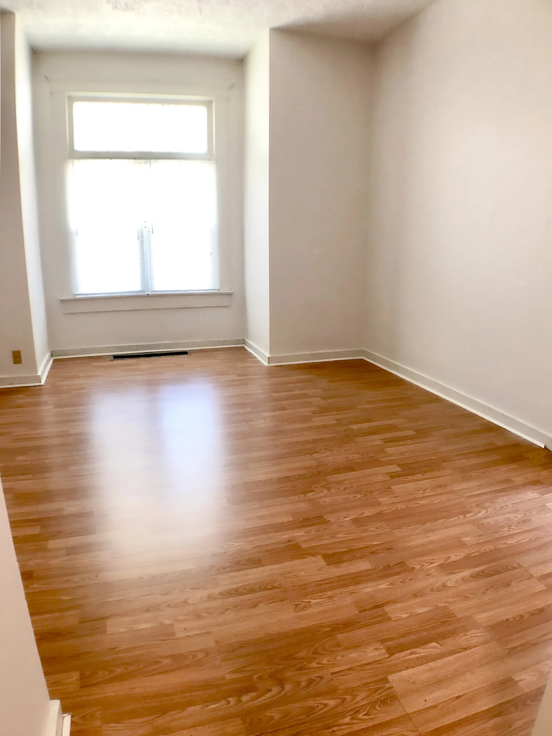 Unit A bright room with hardwood floors and window seat