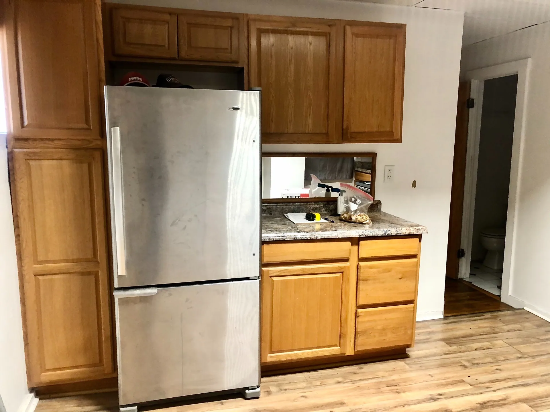 89 E Woodruff Ave. Unit 89 kitchen with full-size stainless fridge and oak cabinets
