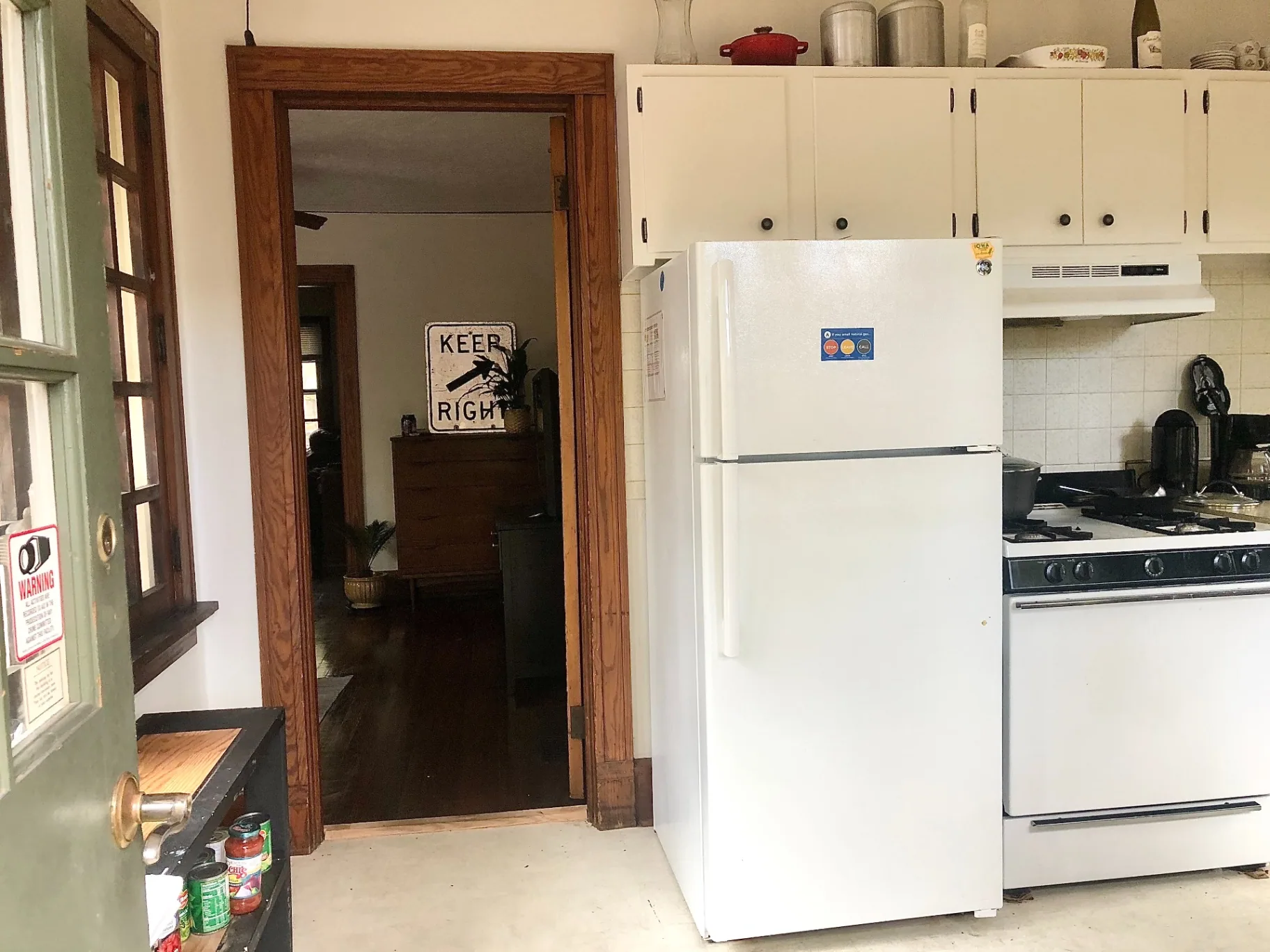 2026 Iuka Ave C kitchen with gas range, refrigerator, and pass-through to dining area
