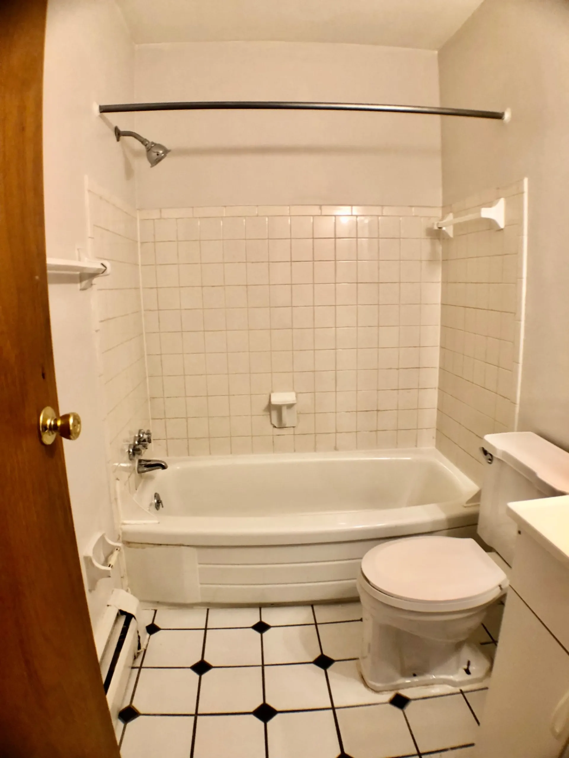 1827 N 4th St. Unit 4 bathroom with tiled tub/shower and checkered tile floor