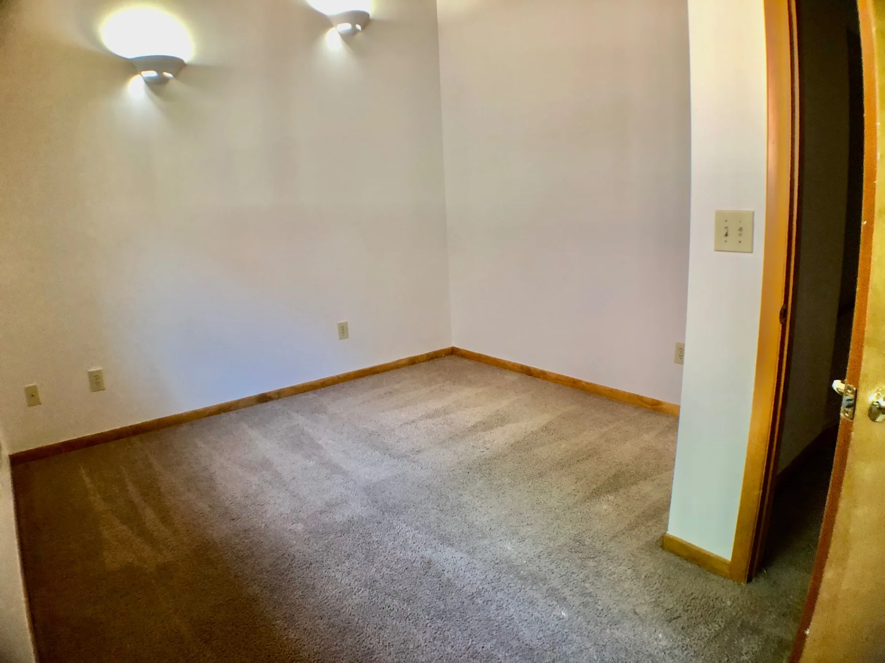 2040 Iuka Ave House bedroom with wall sconces and archway entry