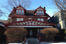 2005 Summit St. exterior — red brick historic home with gabled roof and covered front porch