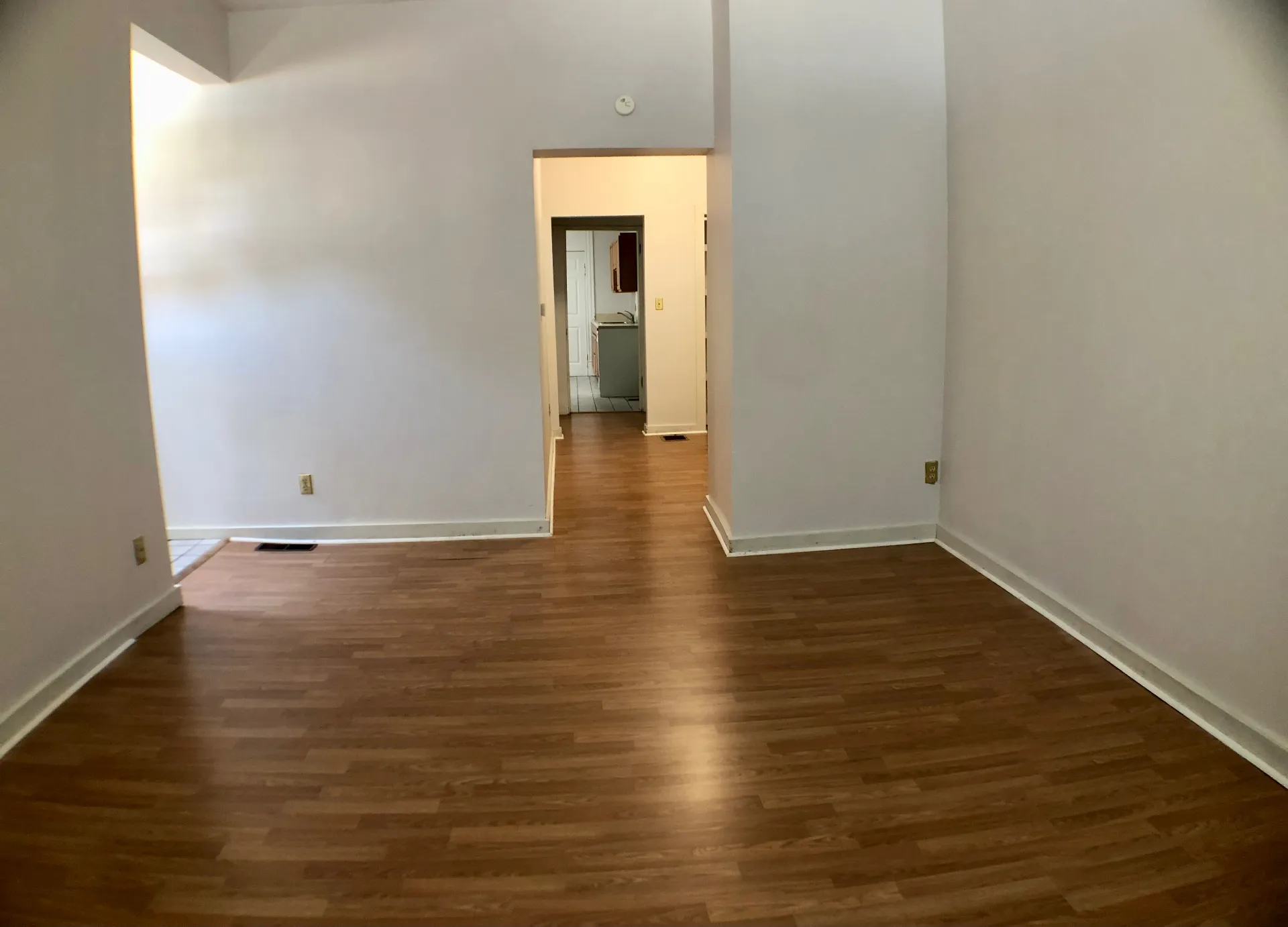 Unit A open living room looking down the hallway toward the kitchen