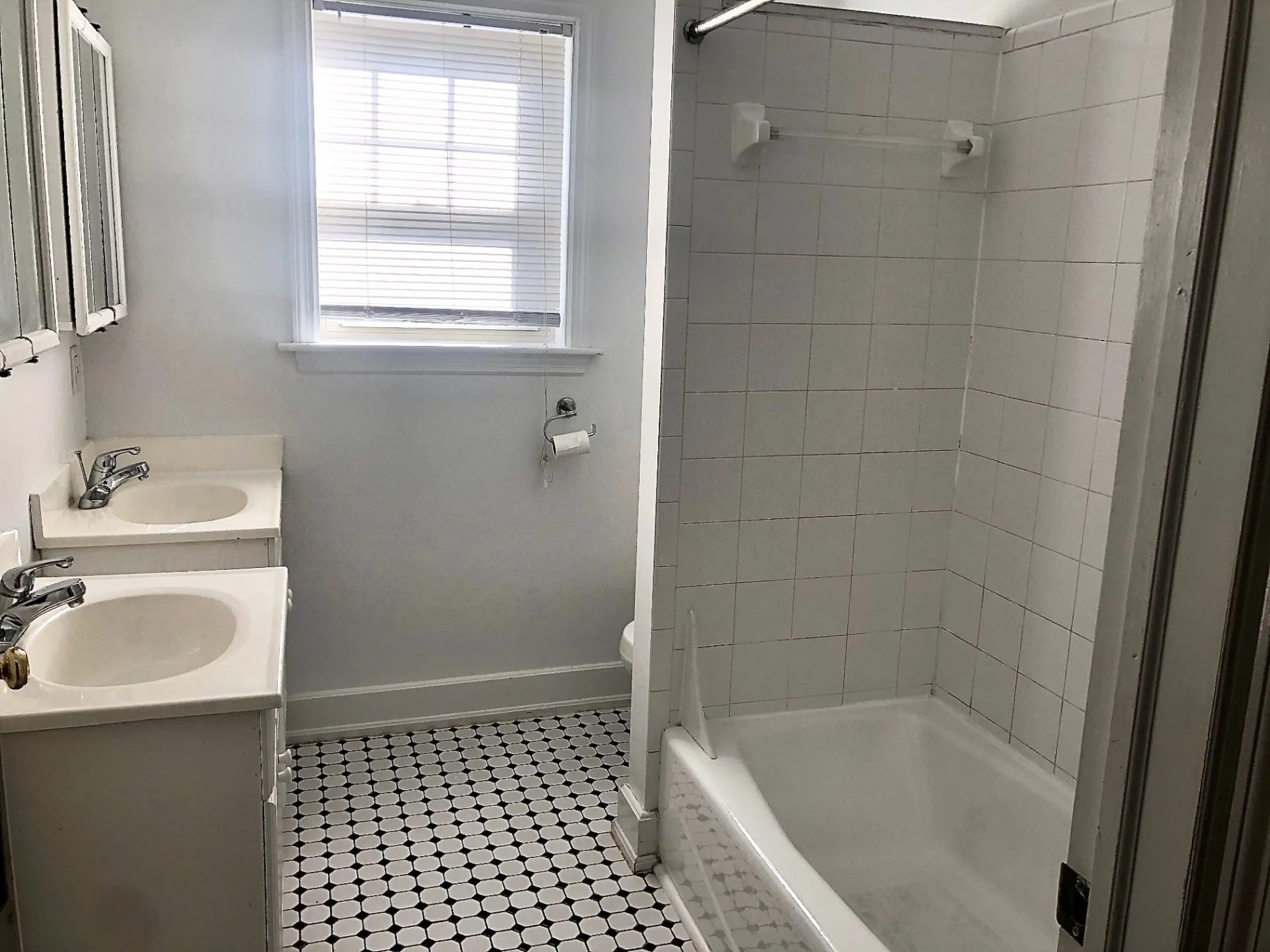 2034 Iuka Ave A double-vanity bathroom with tub and tiled shower