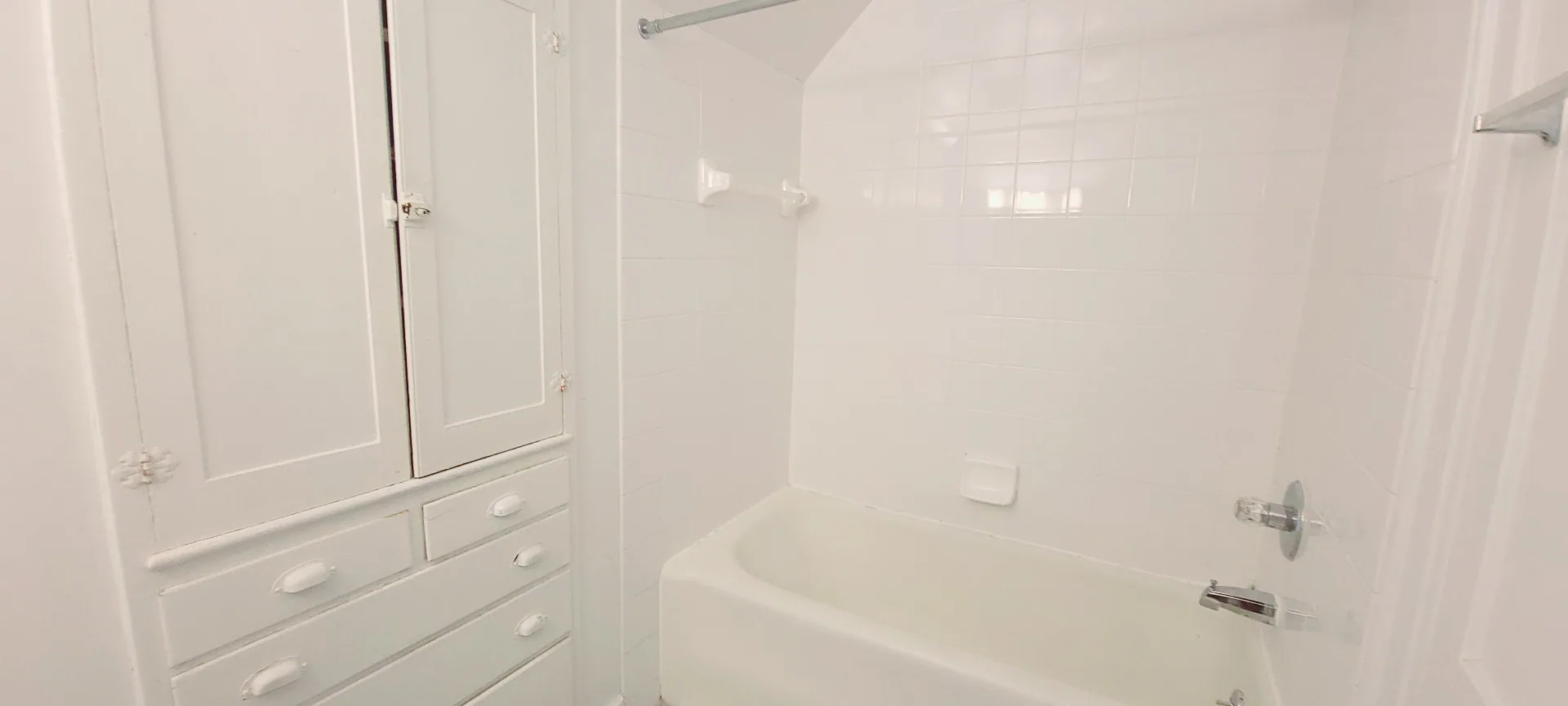 2054 Iuka Ave. C full bathroom with tub surround and built-in storage cabinetry