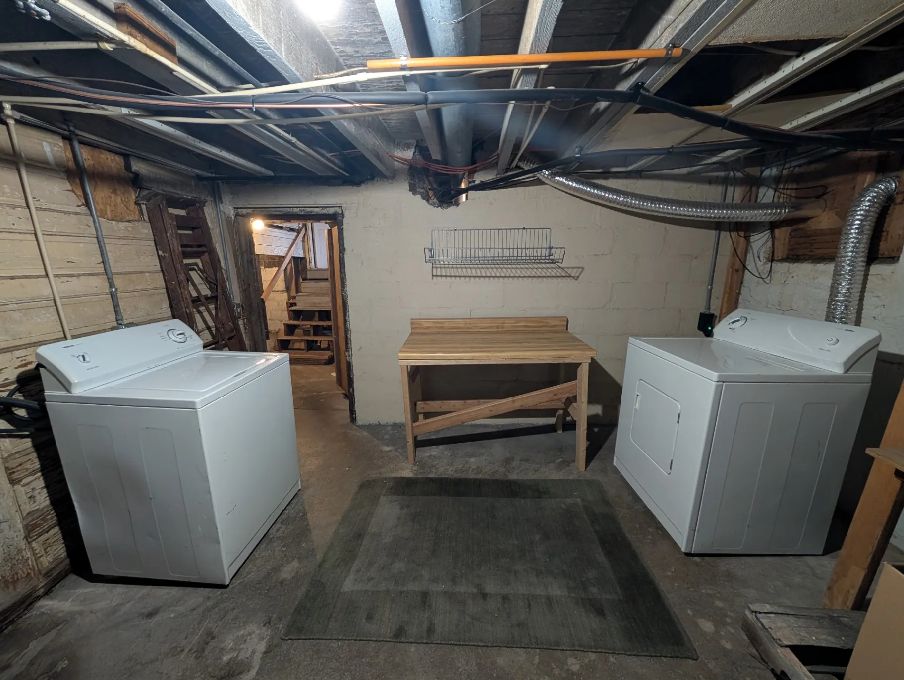 3338 Chestnut shared basement laundry room with washer, dryer and folding table