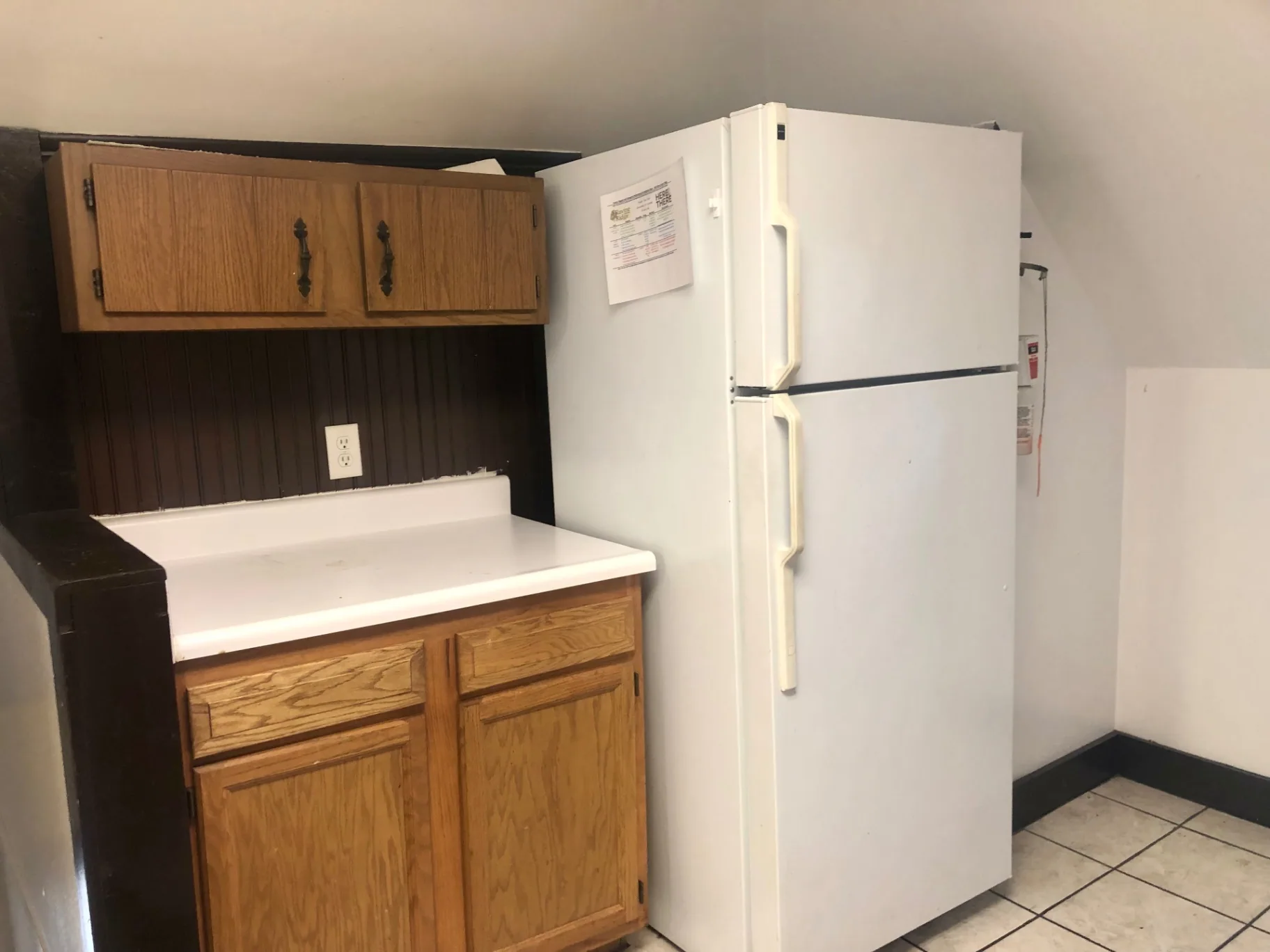91½ E Woodruff Ave. kitchen with full-size refrigerator, upper storage, and extra prep counter