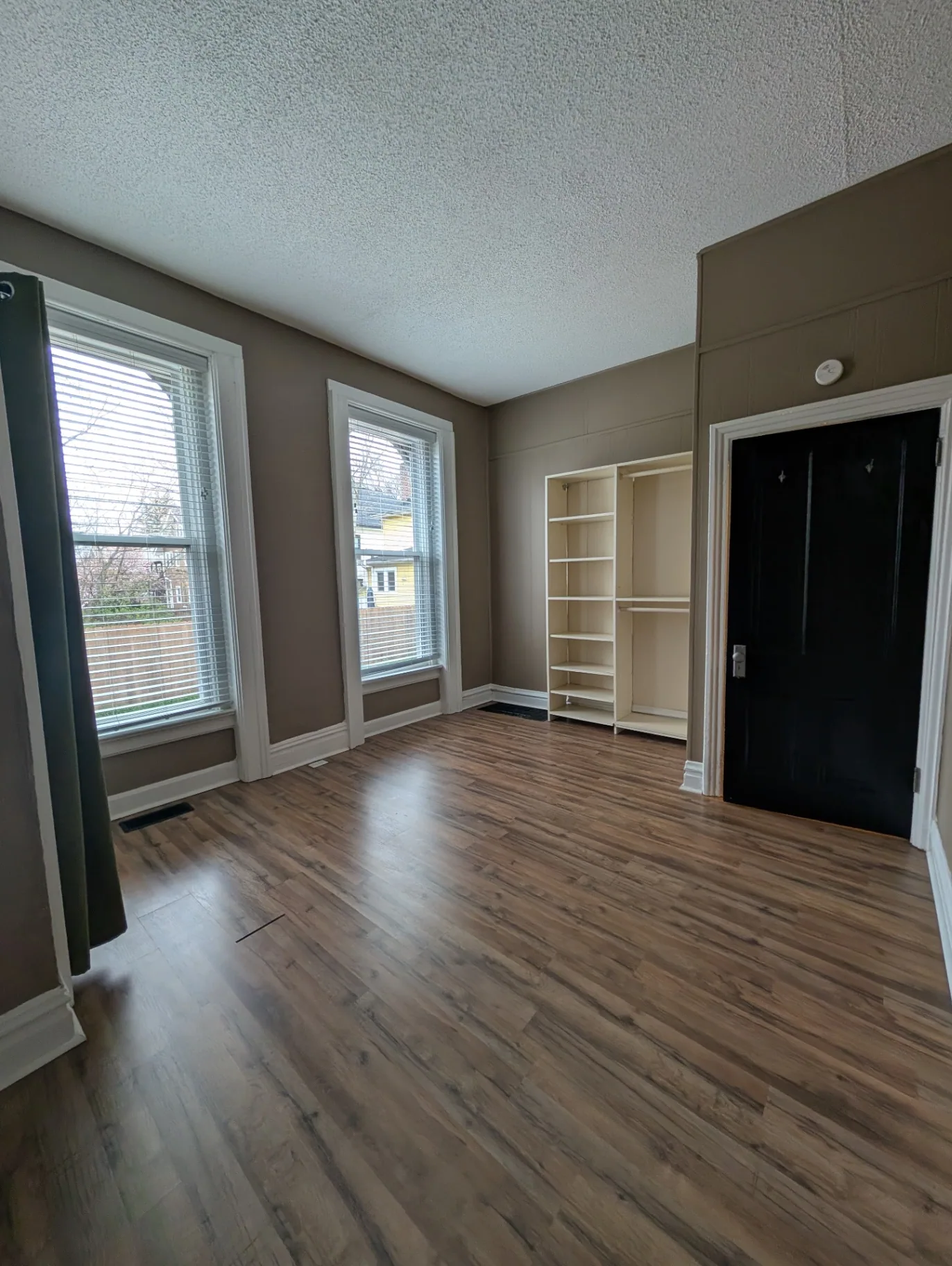 3338 Chestnut Downstairs bedroom with open closet shelving and bright windows