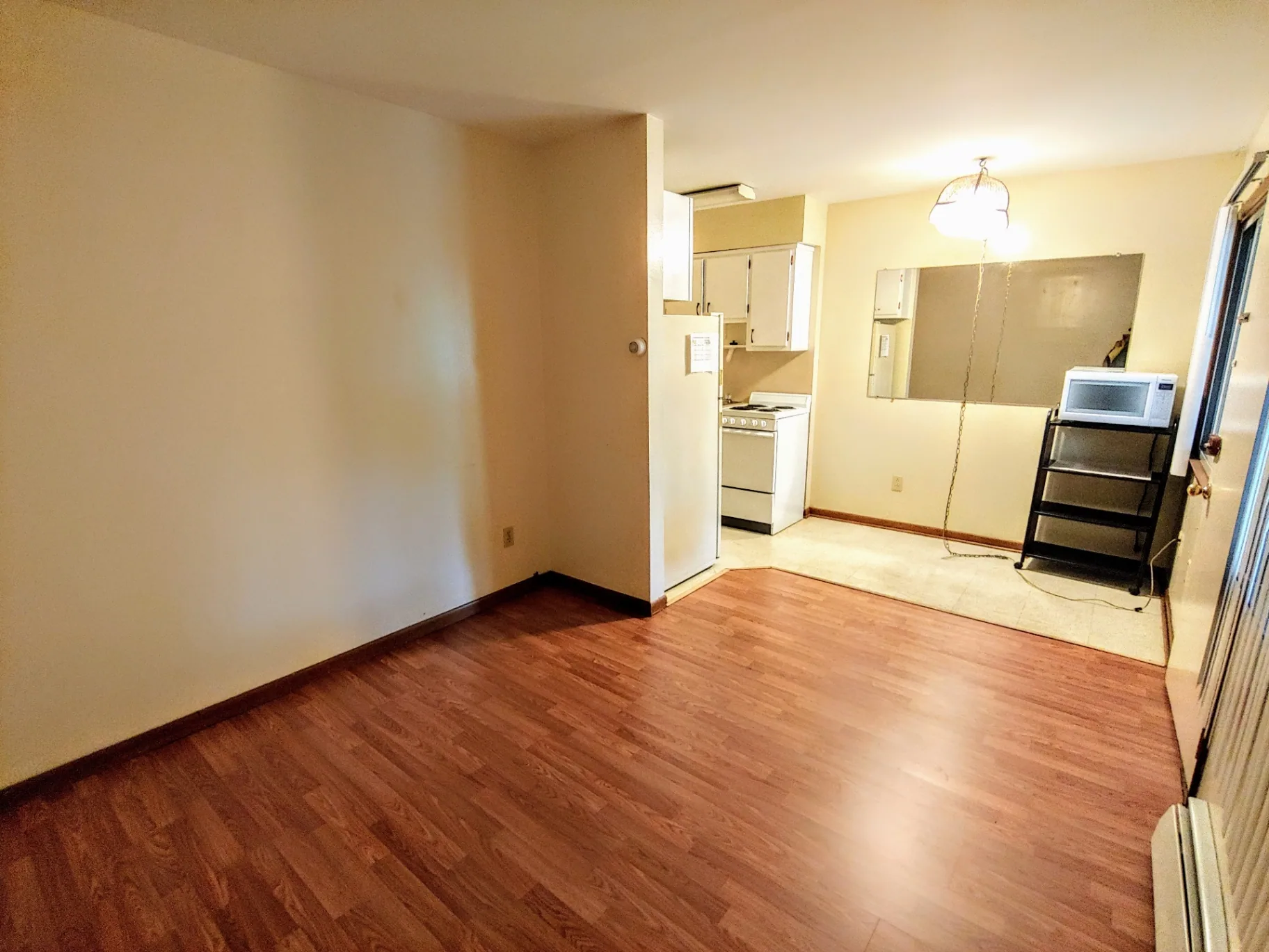 2040 Iuka Ave 4B wide living room view with wood-look floors and natural light
